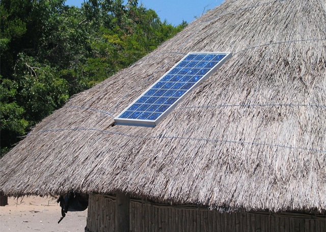 go off-grid in the ultimate way with a solar panel on the thatched roof of a hut